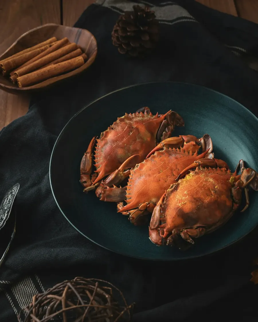 A plate of cooked crabs on a table